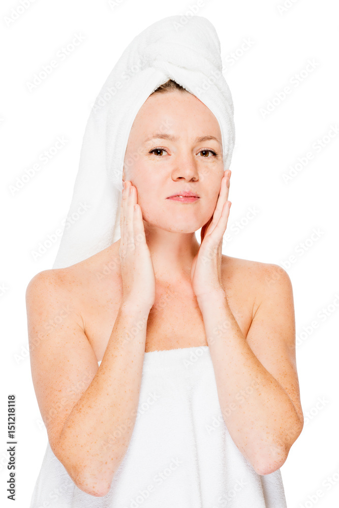 Vertical portrait of a girl who touches the skin after applying cream on a white background Vertical portrait of a girl who touches the skin after applying cream on a white background