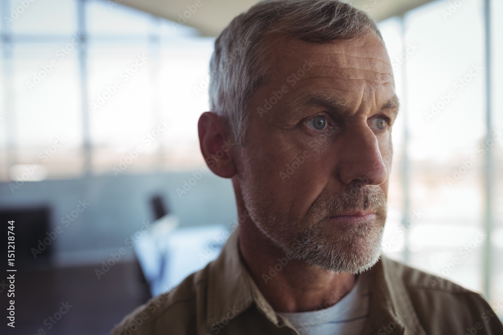 Mature businessman looking away in office Mature businessman looking away in office