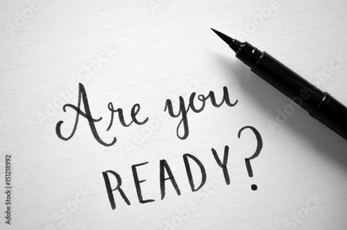 ARE YOU READY? written in notepad on desk with cup of coffee