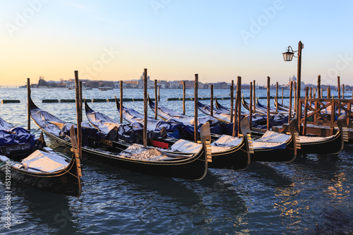 Gondolas covered in snow with view to La Guidecca, sunrise, Venice, UNESCO World Heritage Site, Veneto, Italy, Europe photo