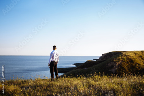 Portrait young business man in suit face to the sea
