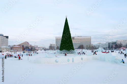 PERM, RUSSIA - JAN 18, 2017: Christmas tree and Perm Ice Town 2017 Ekosad with sculptures - largest in Russia at day