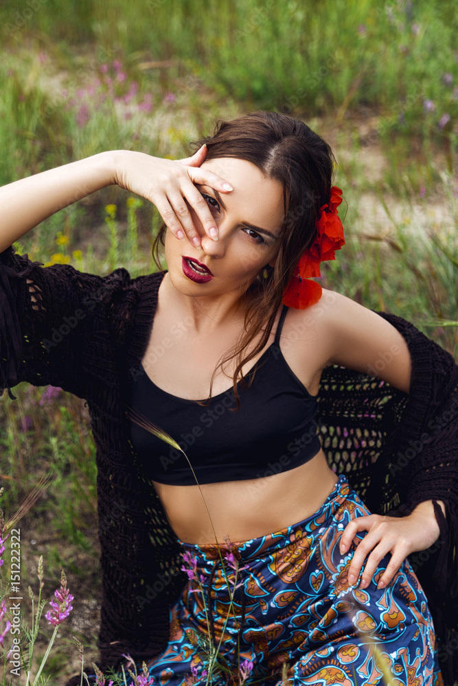 fashion outdoor portrait of a beautiful brunette woman with flowers in hair in the field fashion outdoor portrait of a beautiful brunette woman with flowers in hair in the field