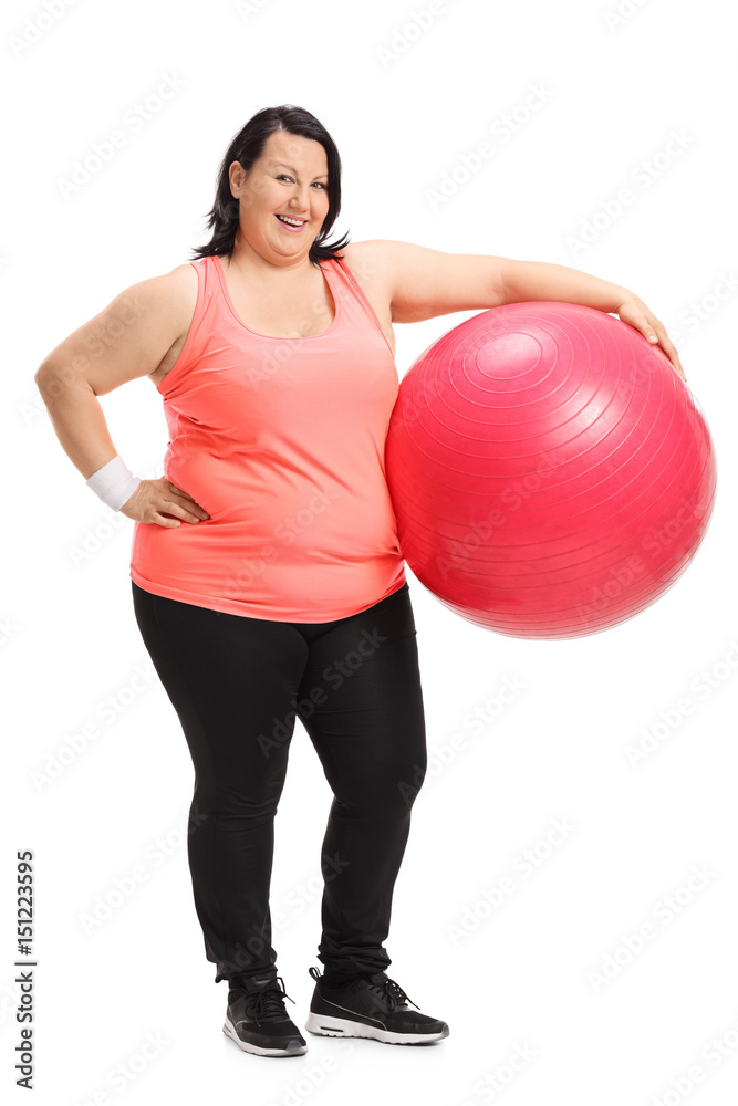 Overweight woman with a pilates ball smiling Overweight woman with a pilates ball smiling