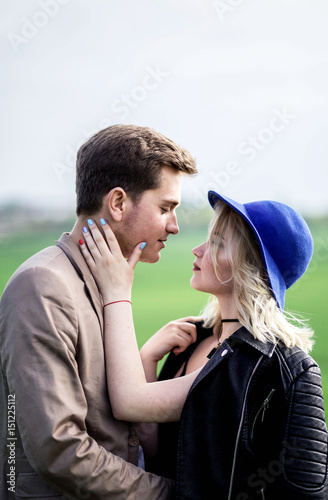 Woman put a hand on the man face