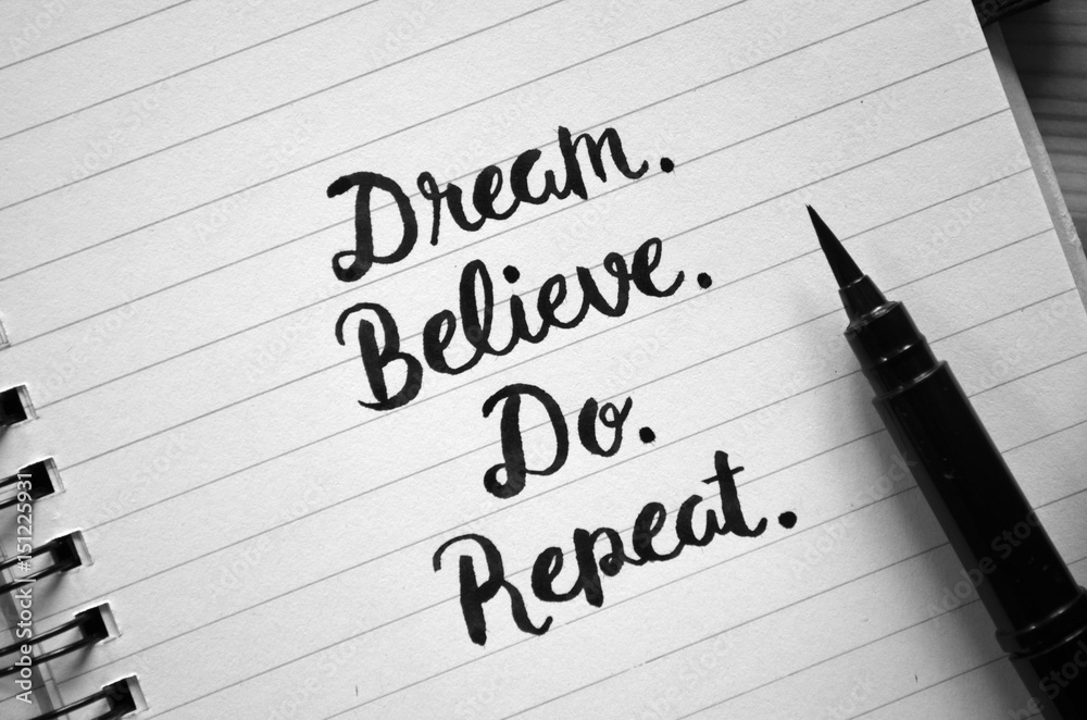 DREAM. BELIEVE. DO. REPEAT. motivational quote written in notebook DREAM. BELIEVE. DO. REPEAT. motivational quote written in notebook