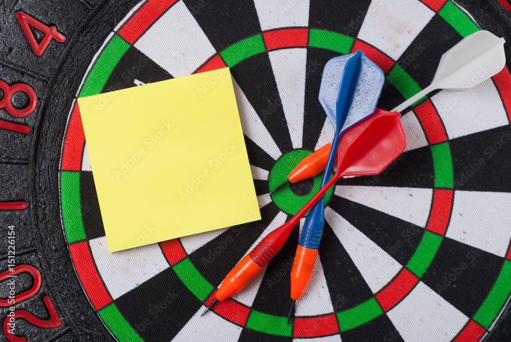 Dart hit the center of the target and attaches the sticker,