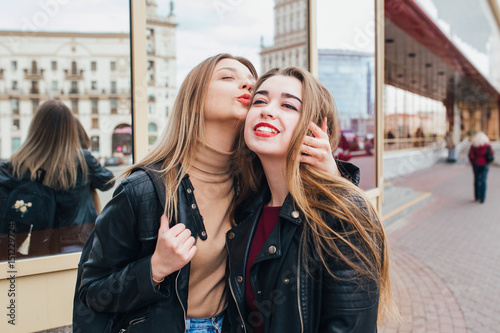 Two friends meeting in the street of the city and hugging . friendship, happiness concept . Couple of woman