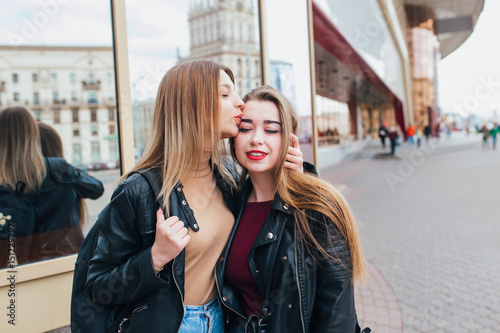 Two friends meeting in the street of the city and hugging . friendship, happiness concept . Couple of woman © Elena Kratovich