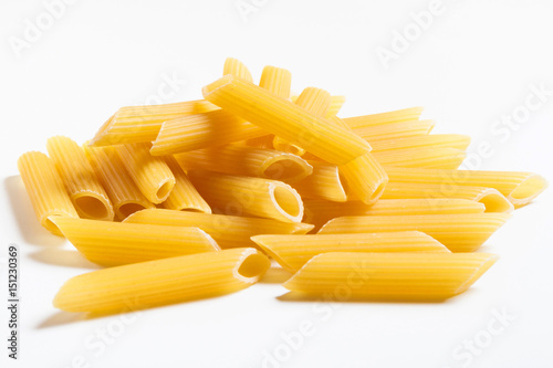 Heap penne pasta isolated on white background.