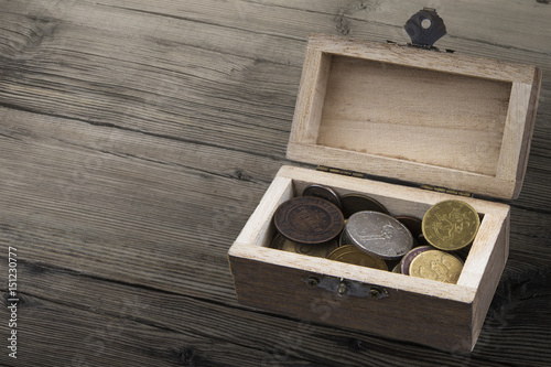 Wooden coffer with coin