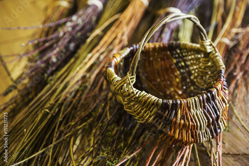 Close up of basket and willow bundles in a basket weaver's workshop. photo