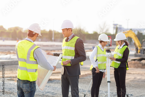 Asian construction engineer,Asian secretary and Asian foreman worker checking construction site for new Infrastructure construction project