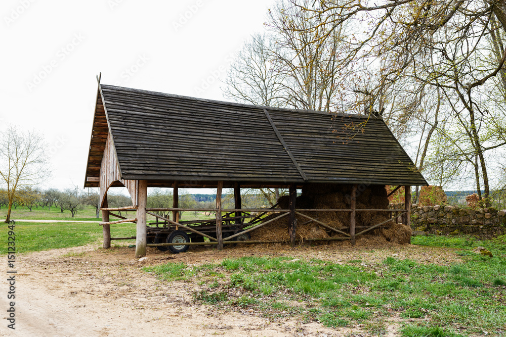 Dry hay stacks in rural wooden barn interior Dry hay stacks in rural wooden barn interior