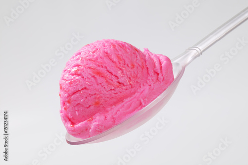 Scoop of pink ice cream on spoon