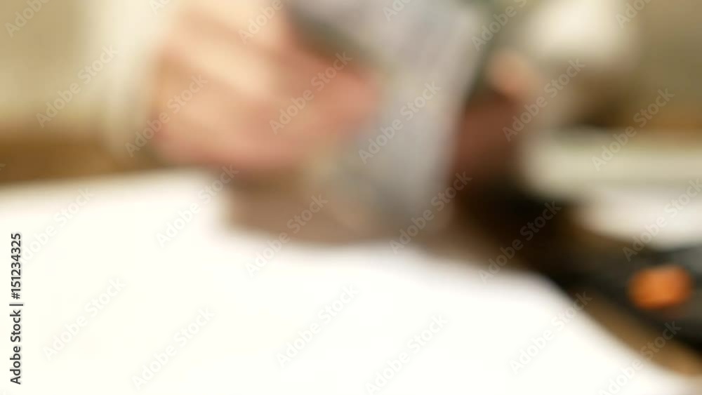 View of woman hands counting dollar bills and showing roll of money, Shallow dof and natural lens blur. View of woman hands counting dollar bills and showing roll of money, Shallow dof and natural lens blur.