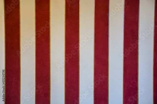Vintage red and white stripes decorated wall in old house