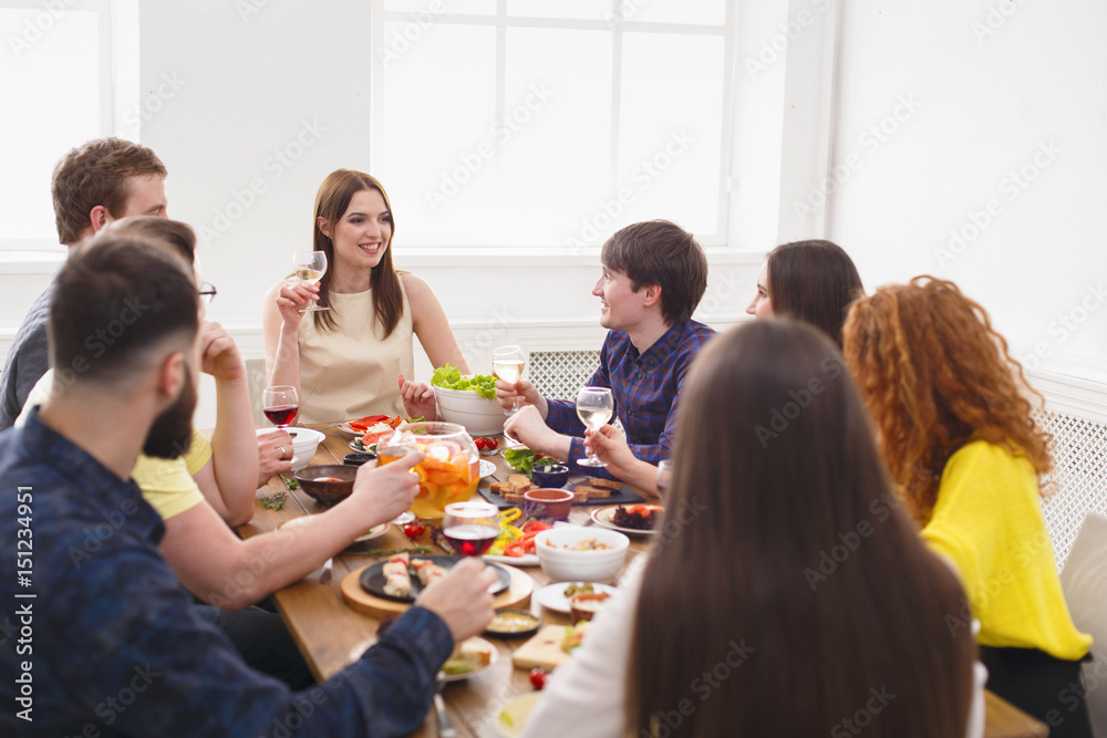 Group of happy people at festive table dinner party Group of happy people at festive table dinner party