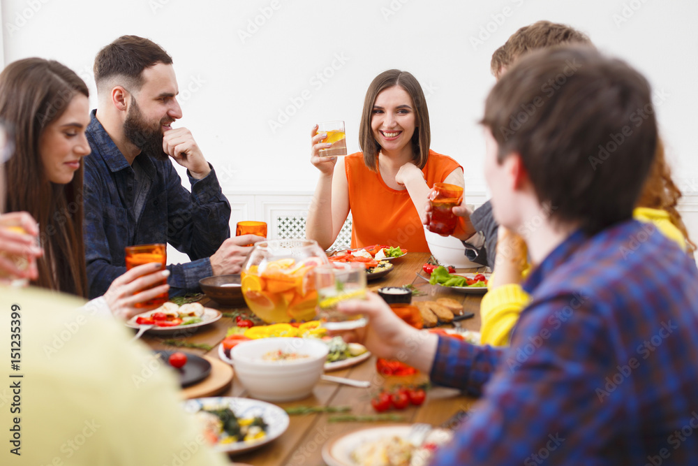 Group of happy people at festive table dinner party