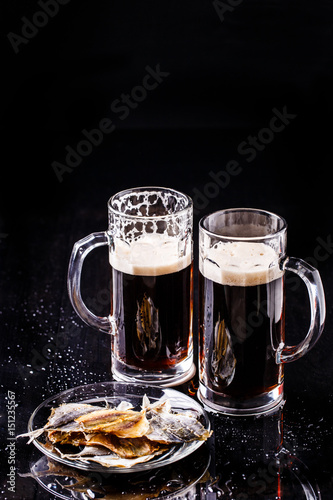 Mugs of beer with fish