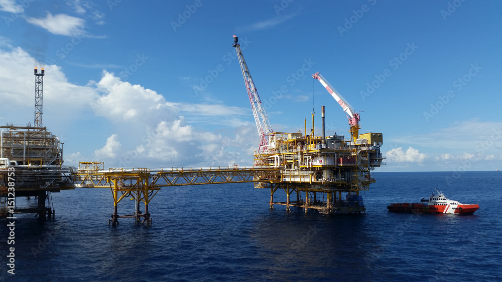 Fototapeta premium Supply boat transfer cargo to oil and gas industry and moving cargo from the boat to the platform