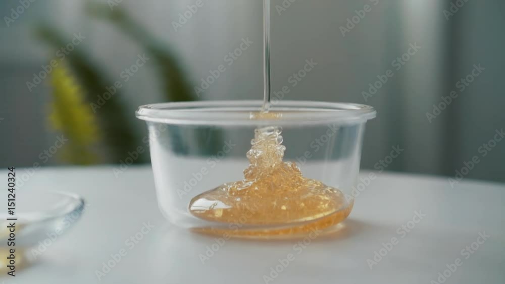 Honey jar. Dripping honey in a jar. Close-up of honey dripping. Honey jar. Dripping honey in a jar. Close-up of honey dripping.