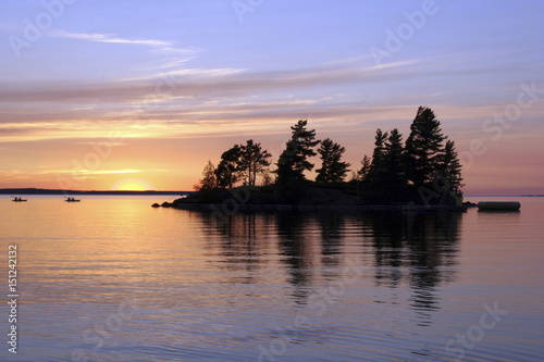 Dramatic cloudy sunset over calm Lake Nipissing, Canada.