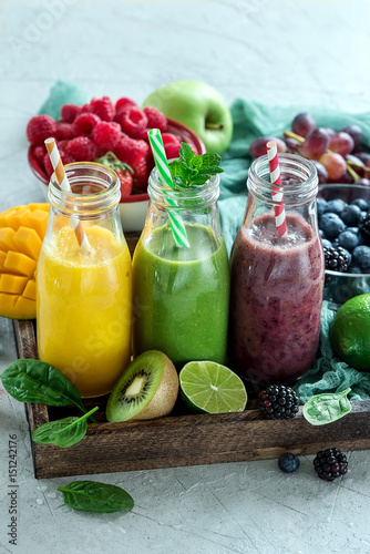 Colorful smoothies in bottles, detox summer diet fresh drink for breakfast or snack.