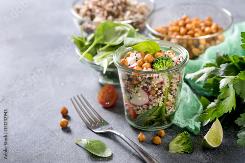 Quinoa salad with chickpeas in mason jar, spinach, veggies, healthy vegan food, dieting, clean eating, vitamin and protein snack