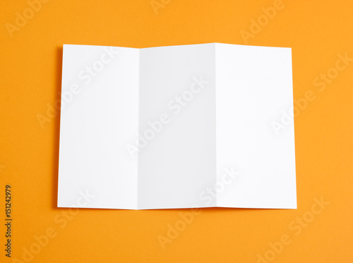 Blank folding page booklet on orange background.