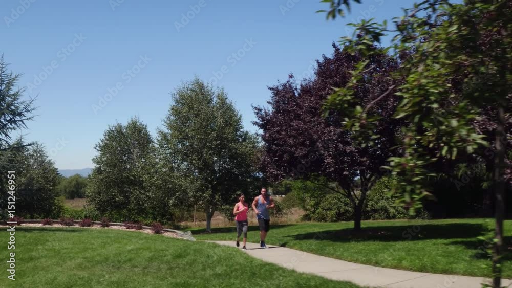 Athletic couple running at park Athletic couple running at park