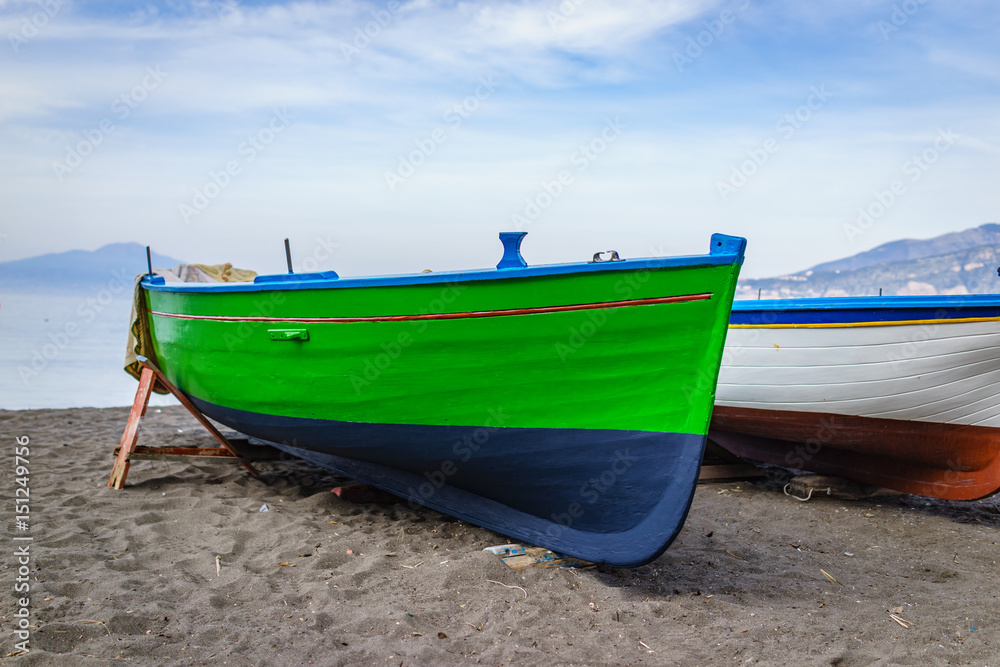 Colorful green fishing boat on a shore coastal sand beach in Positano, south Italy