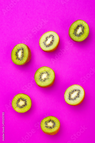 Kiwi fruit pattern on pink colored background, minimal flat lay style, copy space