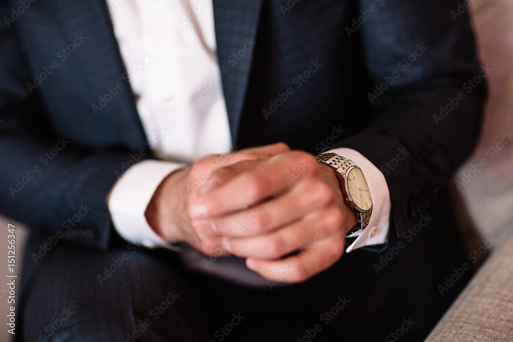 watch with white dial on the hand of a man in a white shirt watch with white dial on the hand of a man in a white shirt