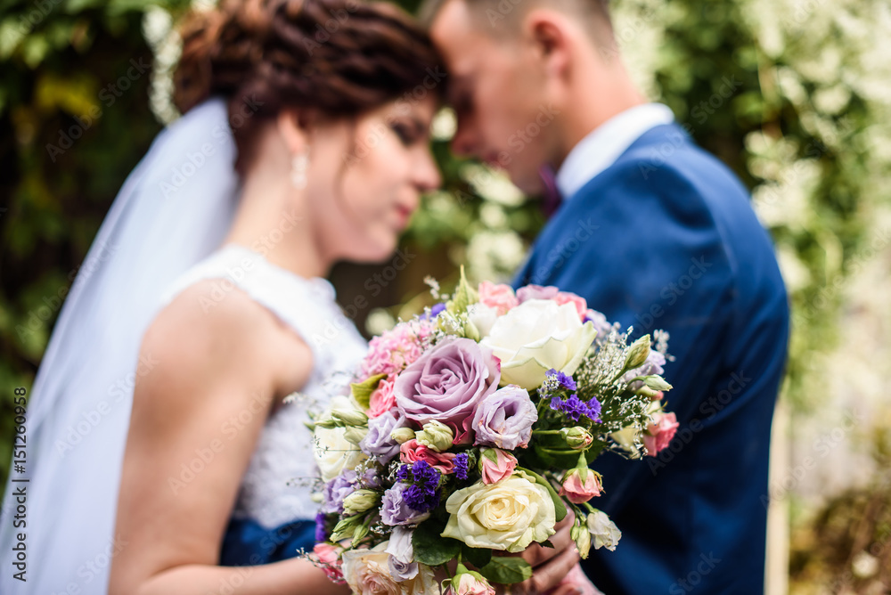 Wedding couple. Happy Bride and groom on their wedding day focus on wedding bouquets Wedding couple. Happy Bride and groom on their wedding day focus on wedding bouquets