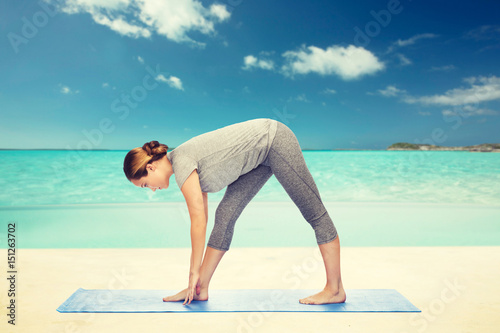 woman making yoga intense stretch pose on mat