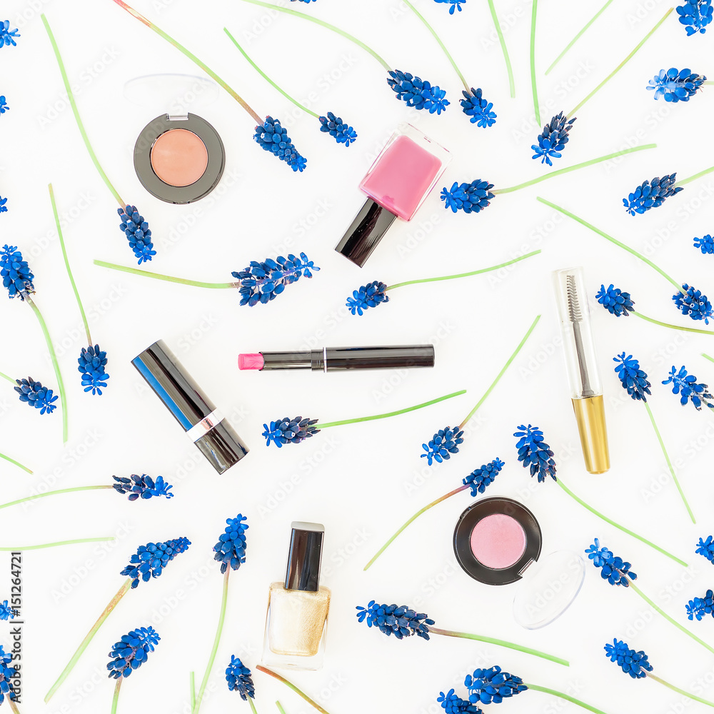 Frame pattern of blue muscari and woman cosmetic on white background. Flat lay, top view. Floral frame. Beauty blog concept Frame pattern of blue muscari and woman cosmetic on white background. Flat lay, top view. Floral frame. Beauty blog concept
