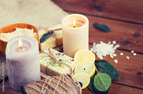 close up of natural soap and candles on wood