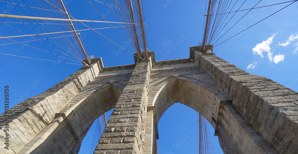 Obraz premium Amazing Architecture in New York - the famous Brooklyn Bridge- MANHATTAN / NEW YORK - APRIL 1, 2017