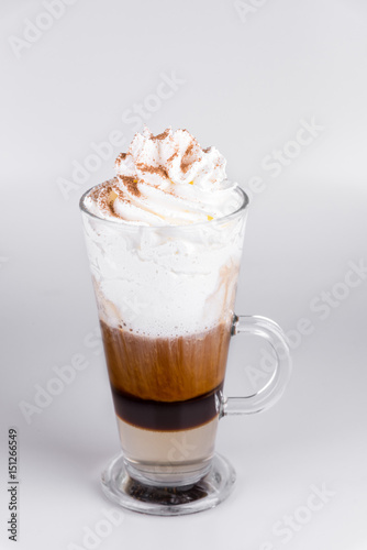 Latte with whipped cream on isolated white background