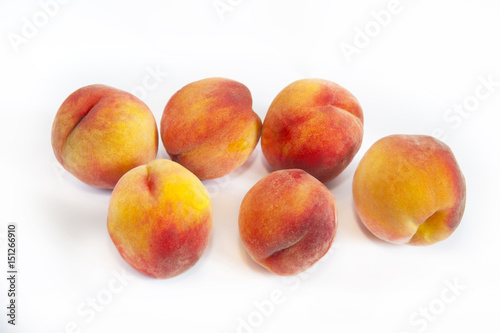 Delicious, juicy peaches on a white background