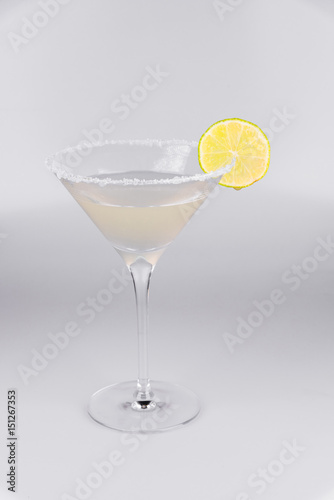 Martini glass with lemon on isolated white background
