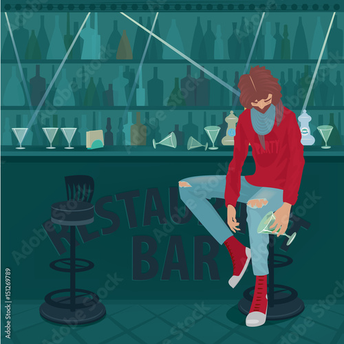 Young fashionable guy got drunk and hardly sits in an empty bar, overturned glasses on a bar counter. Abuse of alcohol concept