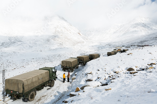 A caravan of Indian army trucks is stucked by snow on the way to Khardung La pass, the highest (5,359 m, 17,582 ft) motorable pass on the world. Ladakh, Jammu and Kashmir, India