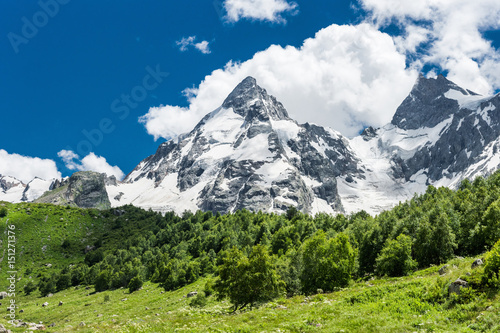 Mt. Dzhan-Tugan with the forest at the foot of it. Adyl-Su gorge in Prielbrusie national park, Kabardino-Balkaria, Russia. photo