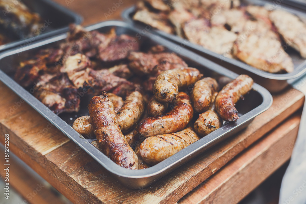 Street fast food, grilled sausages in container