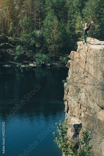 young girl relaxing on the cliff of island near water