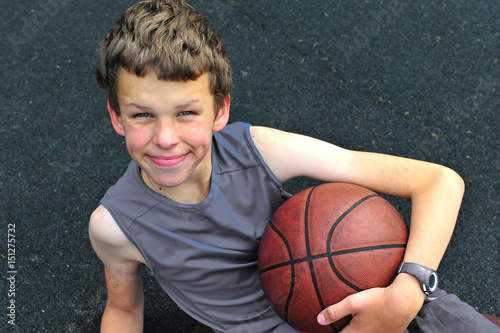 Smiling teenage with a basketball