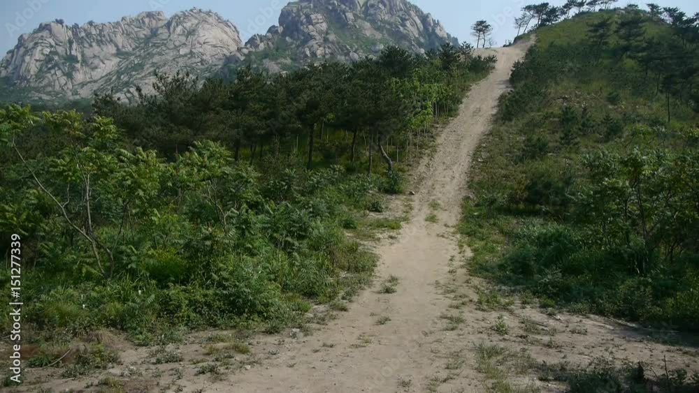 Dirt road leading to the hilltop,steep-rock,Cliff top of the hill. Dirt road leading to the hilltop,steep-rock,Cliff top of the hill.