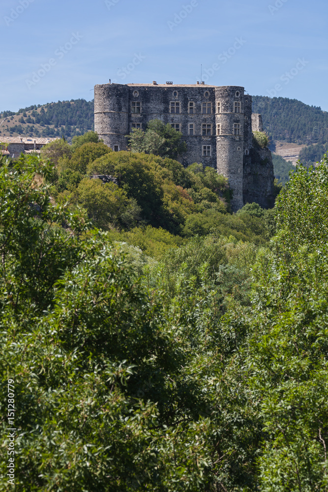 High stones walls of medieval castle Alba-la-Romaine tower on hill on blue sky background in Rhone-Alpes, France